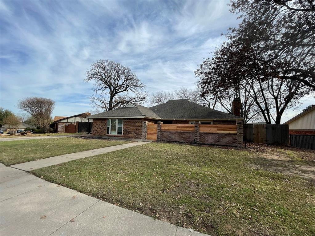 2109 Oakmeadow Street Bedford, TX 76021 - Photo 31 of 31 View of front facade with brick siding, a chimney, and a shingled roof