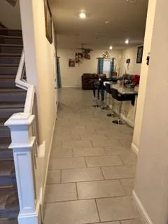 a kitchen with granite countertop a refrigerator and a stove top oven