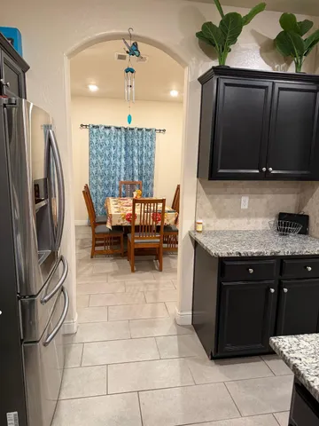 a kitchen with a sink a counter top space appliances and cabinets