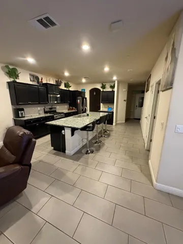 a living room with furniture and a gym machine