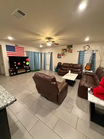 a living room with furniture gym equipment and a table