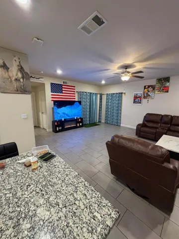a spacious bathroom with a granite countertop sink and a mirror