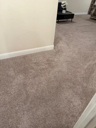 a view of a street with a building and trees in the background