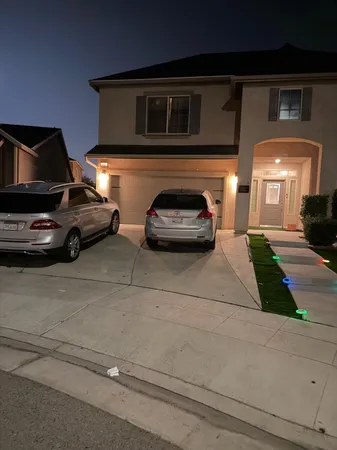 a front view of a house with a yard and a garage