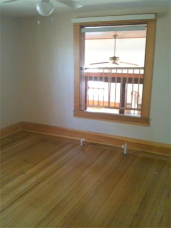 2-4 Evergreen Avenue Newton, MA 02466 - Photo 19 of 23 a view of an empty room with wooden floor and a window