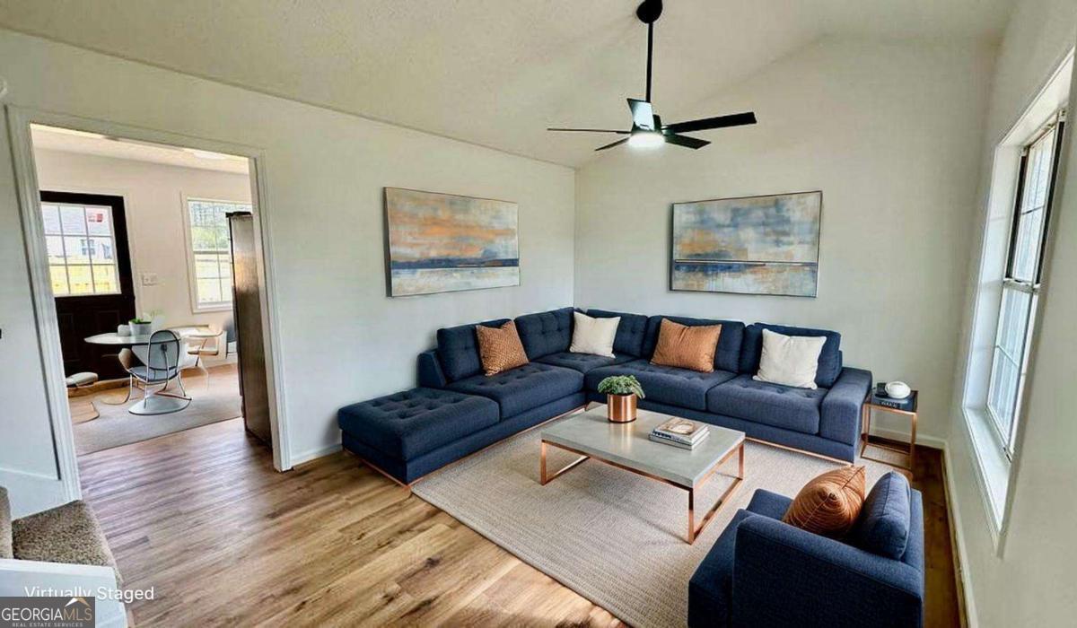 2095 4 Notch Road Carrollton, GA 30116 - Photo 12 of 53 a living room with furniture and a wooden floor