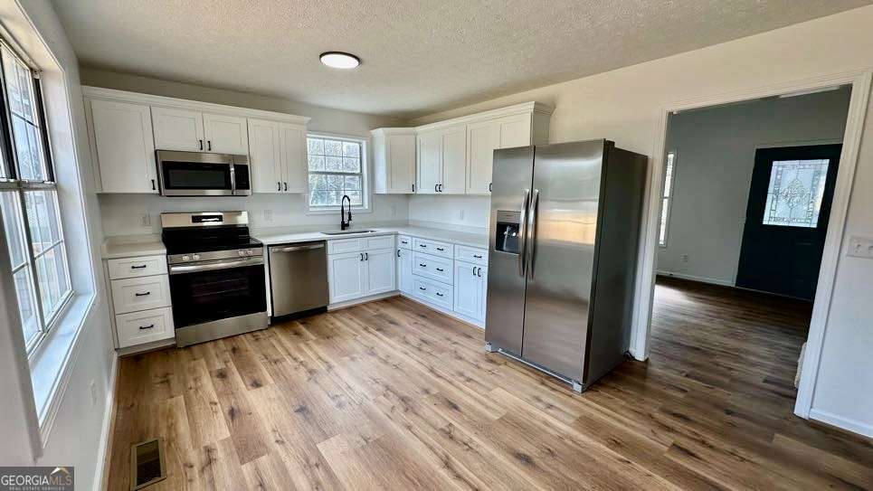 2095 4 Notch Road Carrollton, GA 30116 - Photo 14 of 53 a kitchen with stainless steel appliances granite countertop a refrigerator a stove top oven a sink and dishwasher