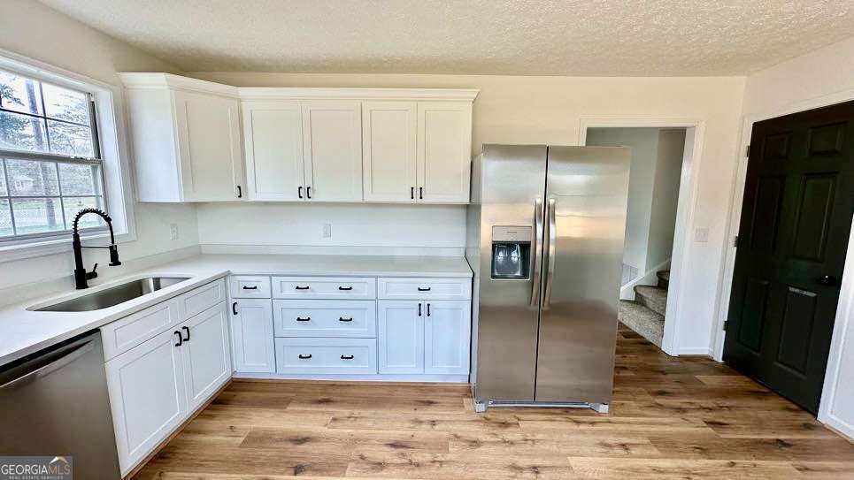 2095 4 Notch Road Carrollton, GA 30116 - Photo 16 of 53 a kitchen with a refrigerator sink and cabinets