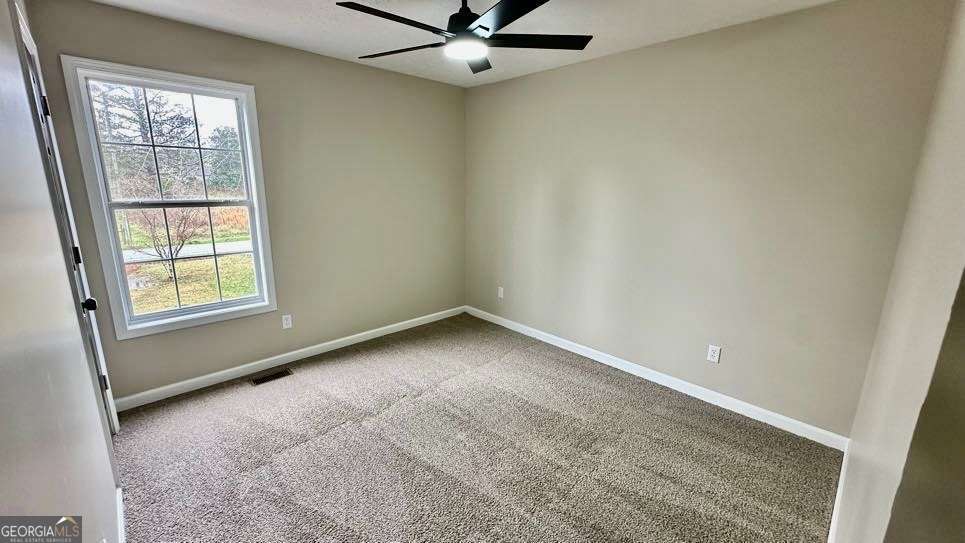 2095 4 Notch Road Carrollton, GA 30116 - Photo 24 of 53 an empty room with a window and ceiling fan