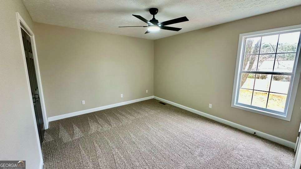 2095 4 Notch Road Carrollton, GA 30116 - Photo 26 of 53 an empty room with a window and a ceiling fan
