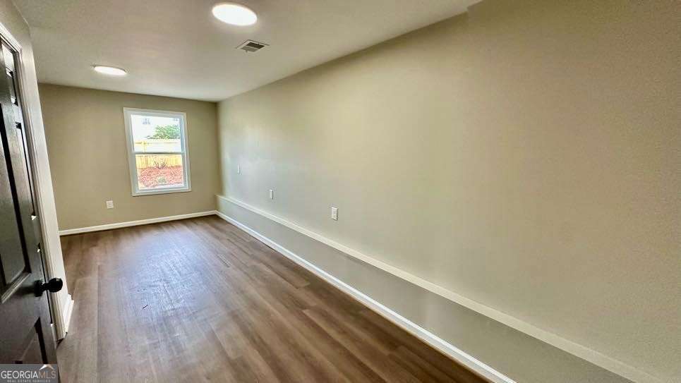 2095 4 Notch Road Carrollton, GA 30116 - Photo 34 of 53 a view of an empty room with wooden floor and a window