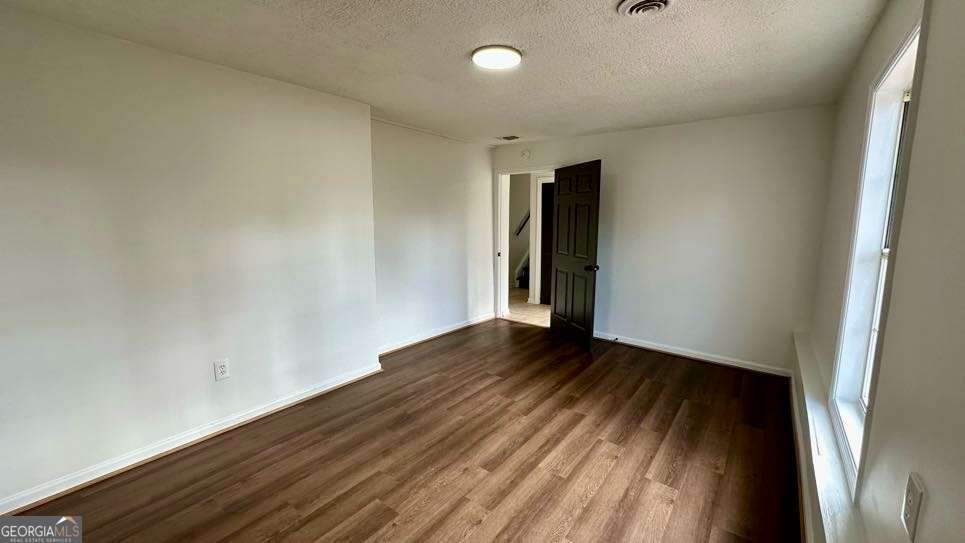 2095 4 Notch Road Carrollton, GA 30116 - Photo 41 of 53 a view of an empty room with wooden floor and a window