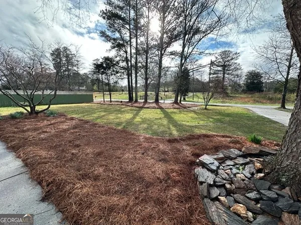 a kitchen with stainless steel appliances granite countertop a refrigerator a stove top oven a sink and dishwasher