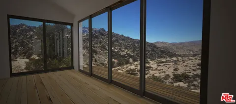 a view of a dry yard with a mountain view