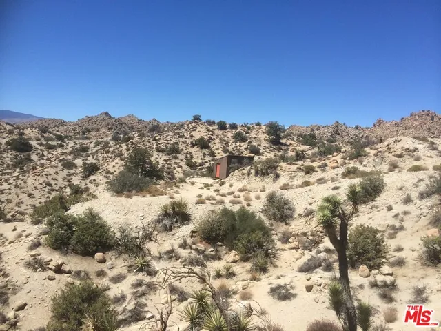 a view of a house with a mountain and a forest