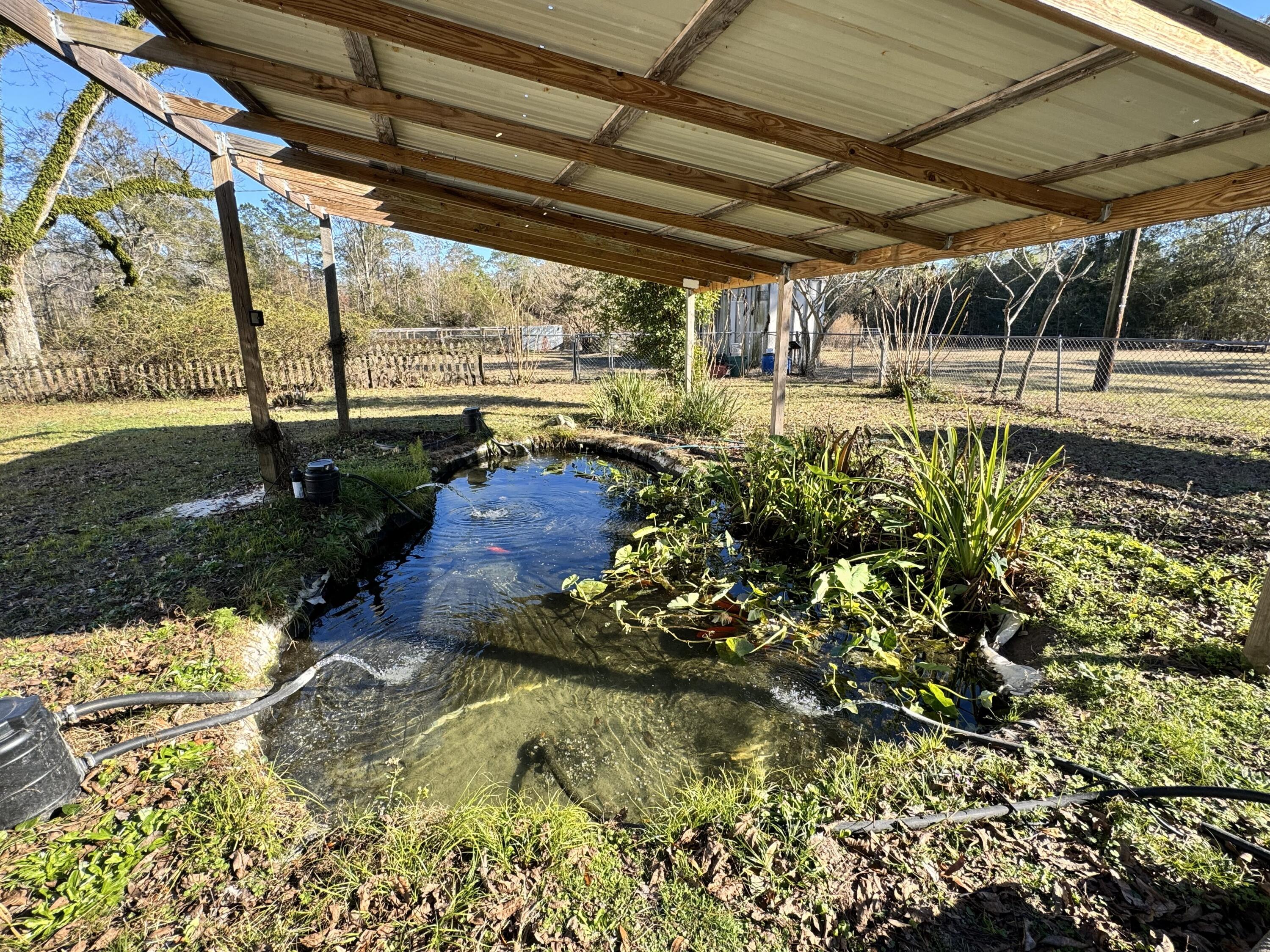 2864 Sixth Street Florala, AL 36442 - Photo 27 of 28 a view of a porch with a table and chairs