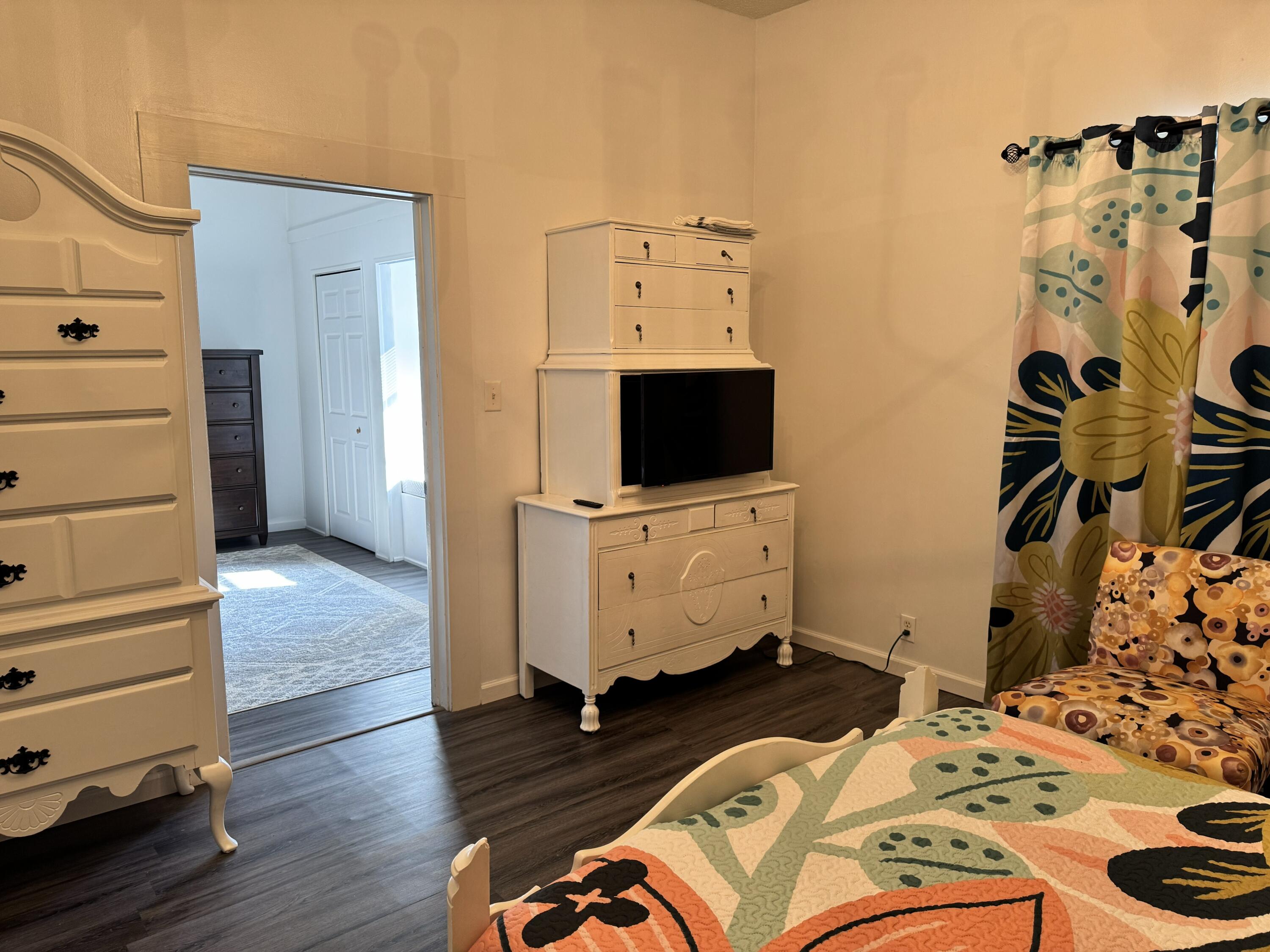 2864 Sixth Street Florala, AL 36442 - Photo 9 of 28 a bedroom with a bed and wooden floor