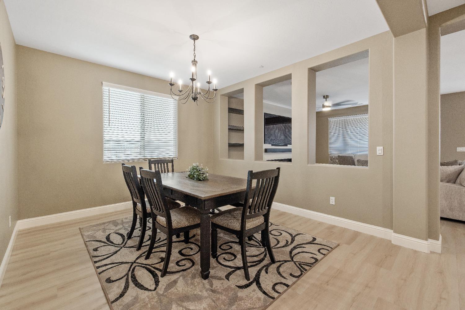 1210 Ridge Creek Estates Way Dinuba, CA 93618 - Photo 11 of 50 a view of a dining room with furniture and chandelier