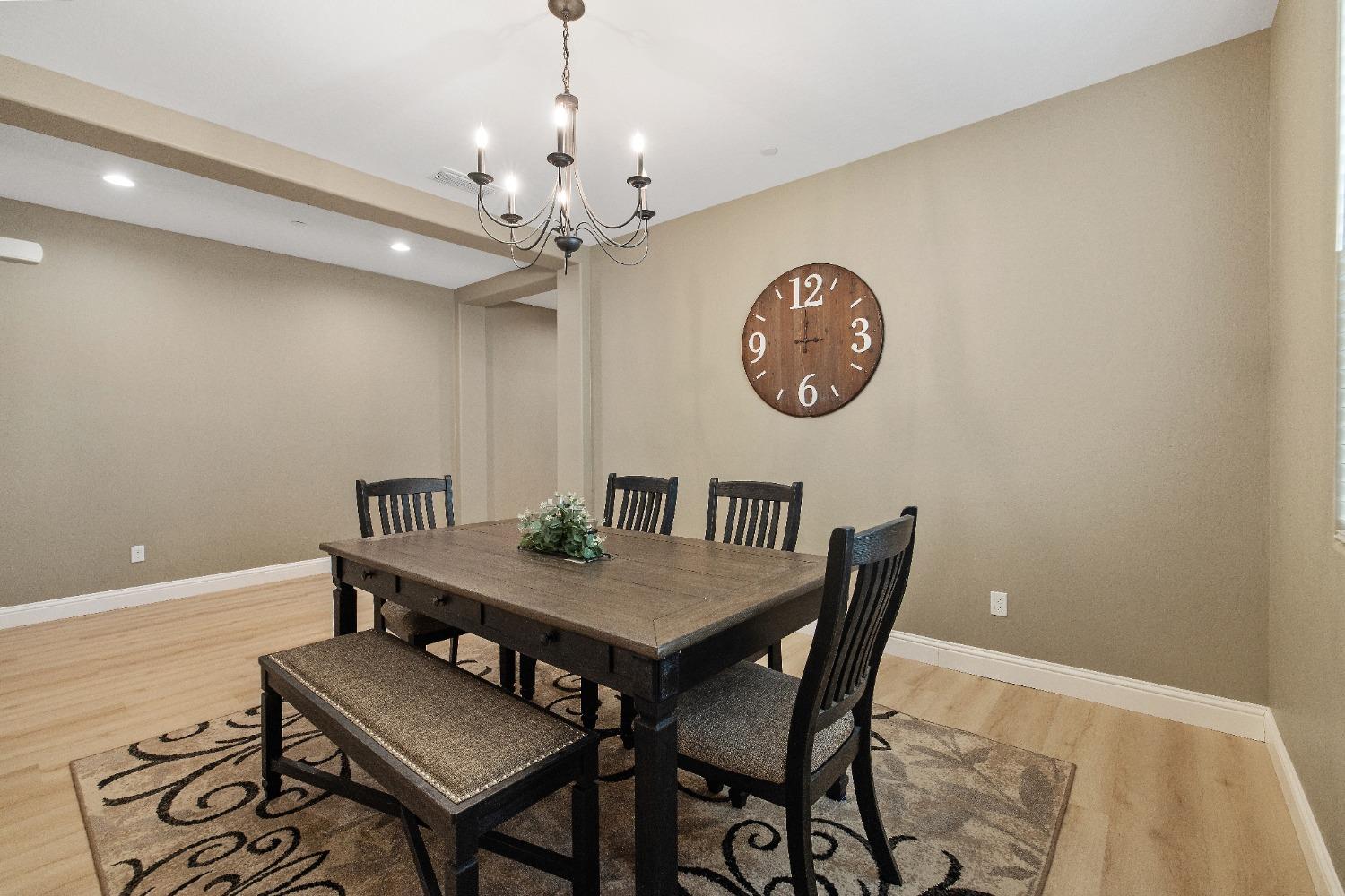 1210 Ridge Creek Estates Way Dinuba, CA 93618 - Photo 14 of 50 a view of a dining room with furniture and chandelier