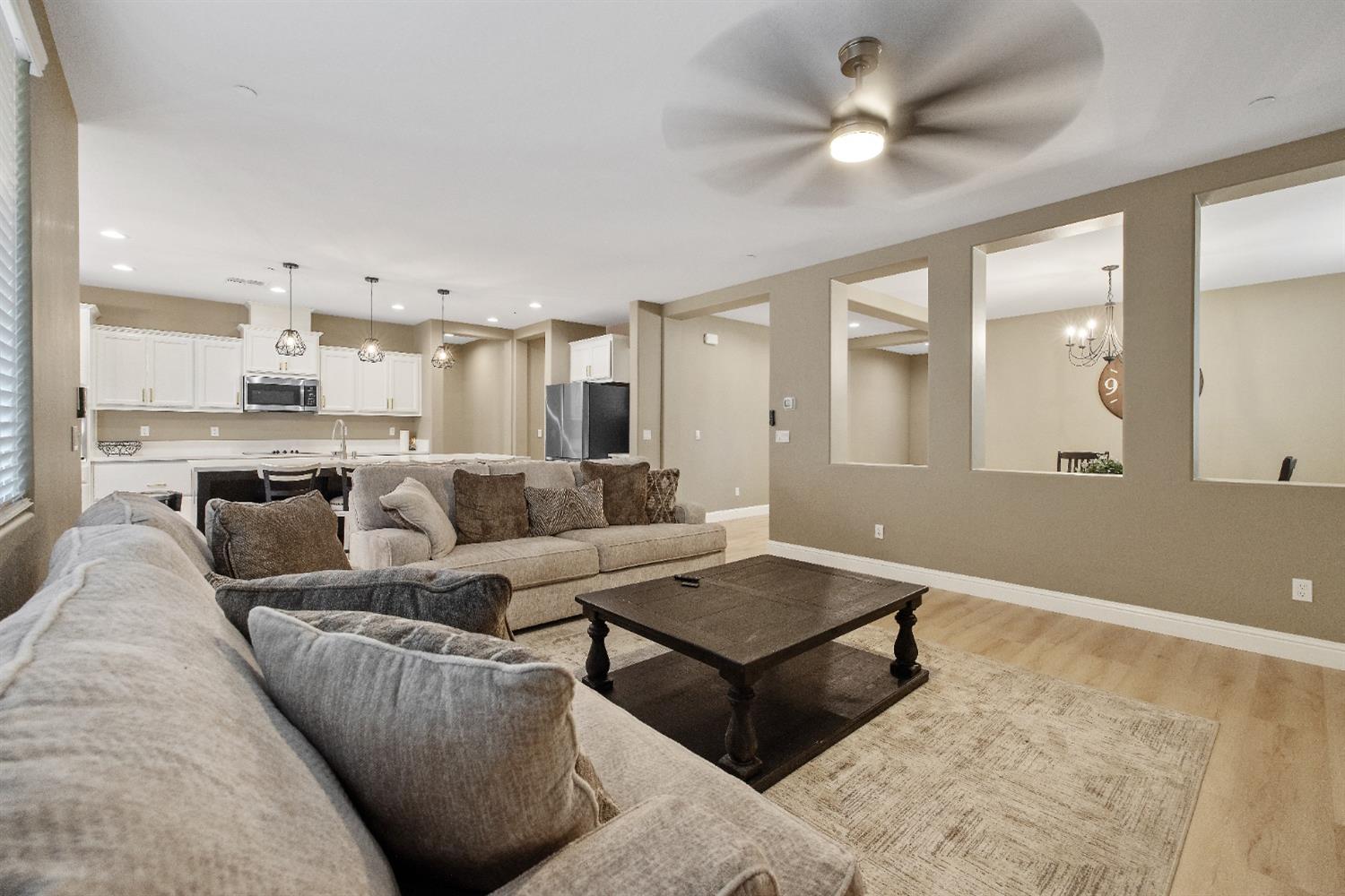 1210 Ridge Creek Estates Way Dinuba, CA 93618 - Photo 21 of 50 a living room with furniture and a chandelier
