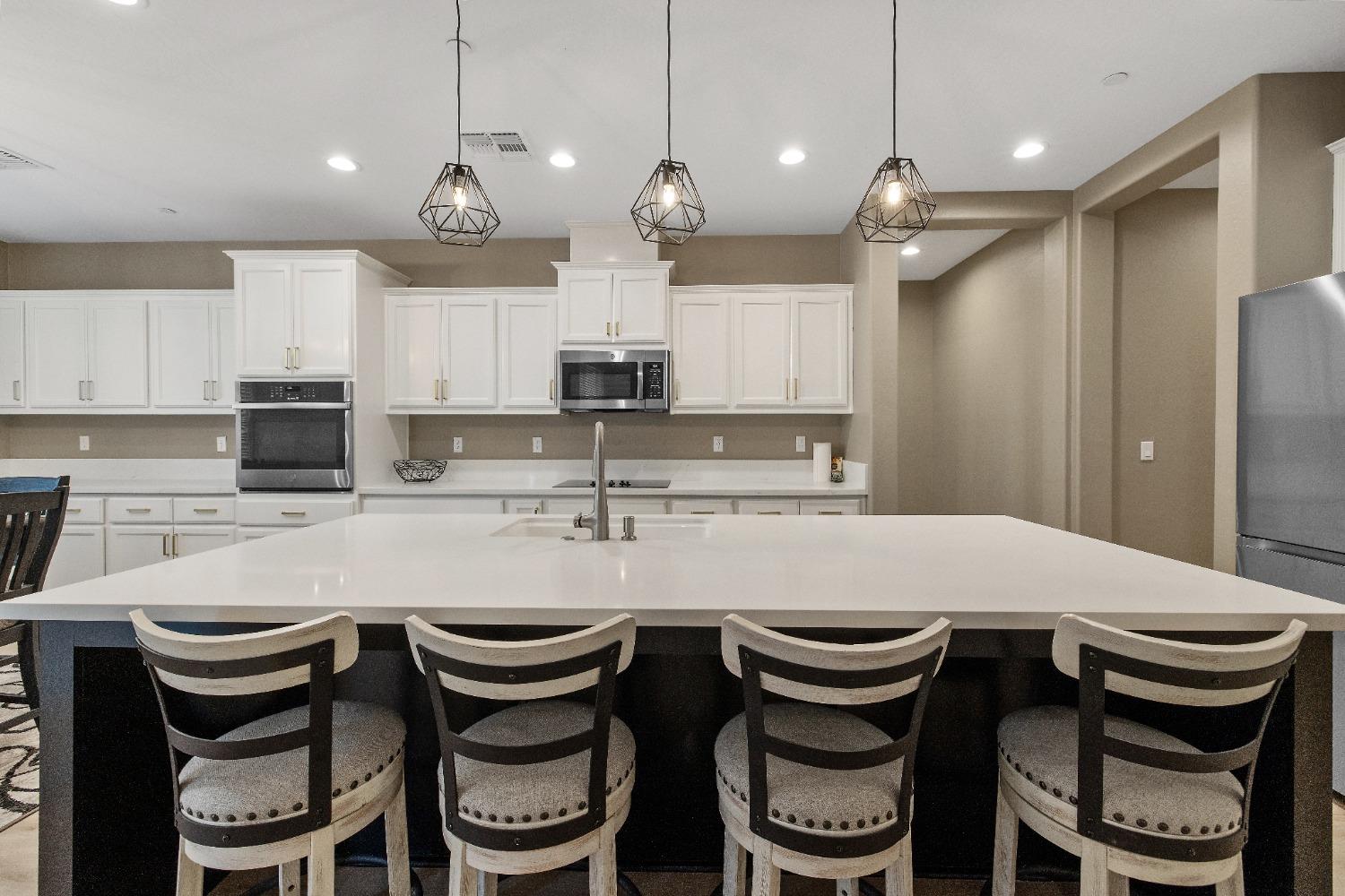 1210 Ridge Creek Estates Way Dinuba, CA 93618 - Photo 25 of 50 a kitchen with a dining table and chairs