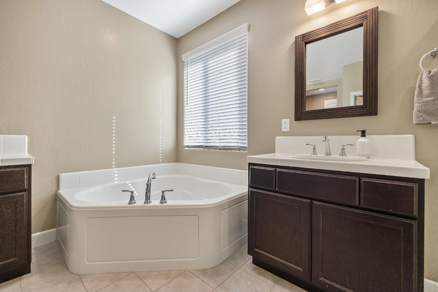 1210 Ridge Creek Estates Way Dinuba, CA 93618 - Photo 37 of 50 a bathroom with a bathtub and a sink