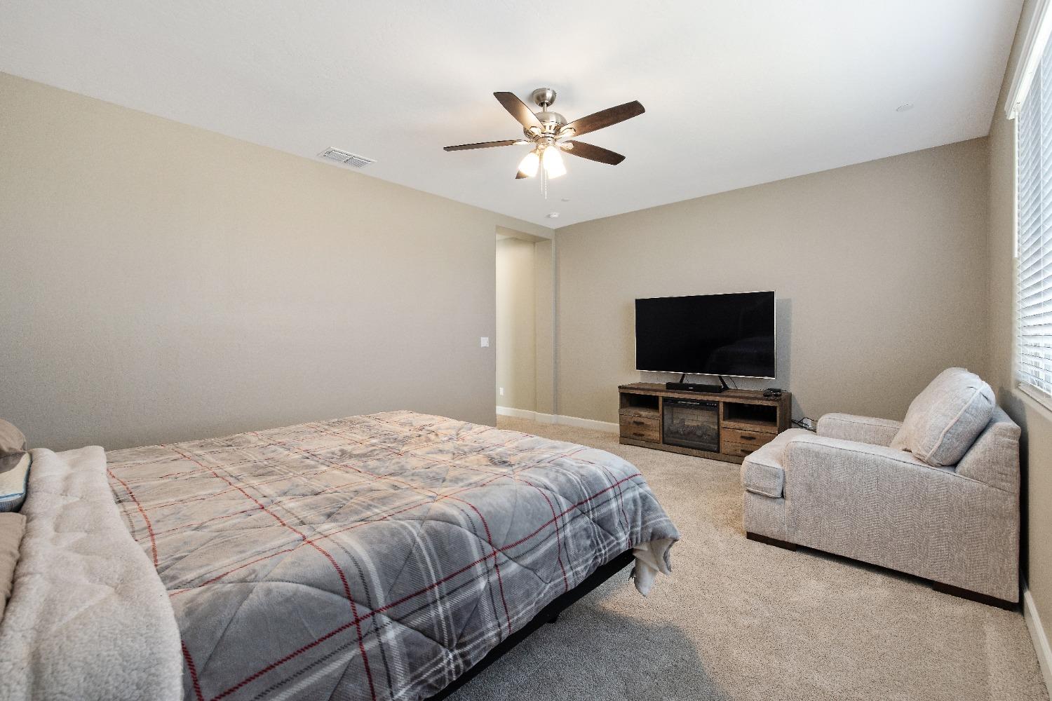 1210 Ridge Creek Estates Way Dinuba, CA 93618 - Photo 40 of 50 a bedroom with bed tv and couch