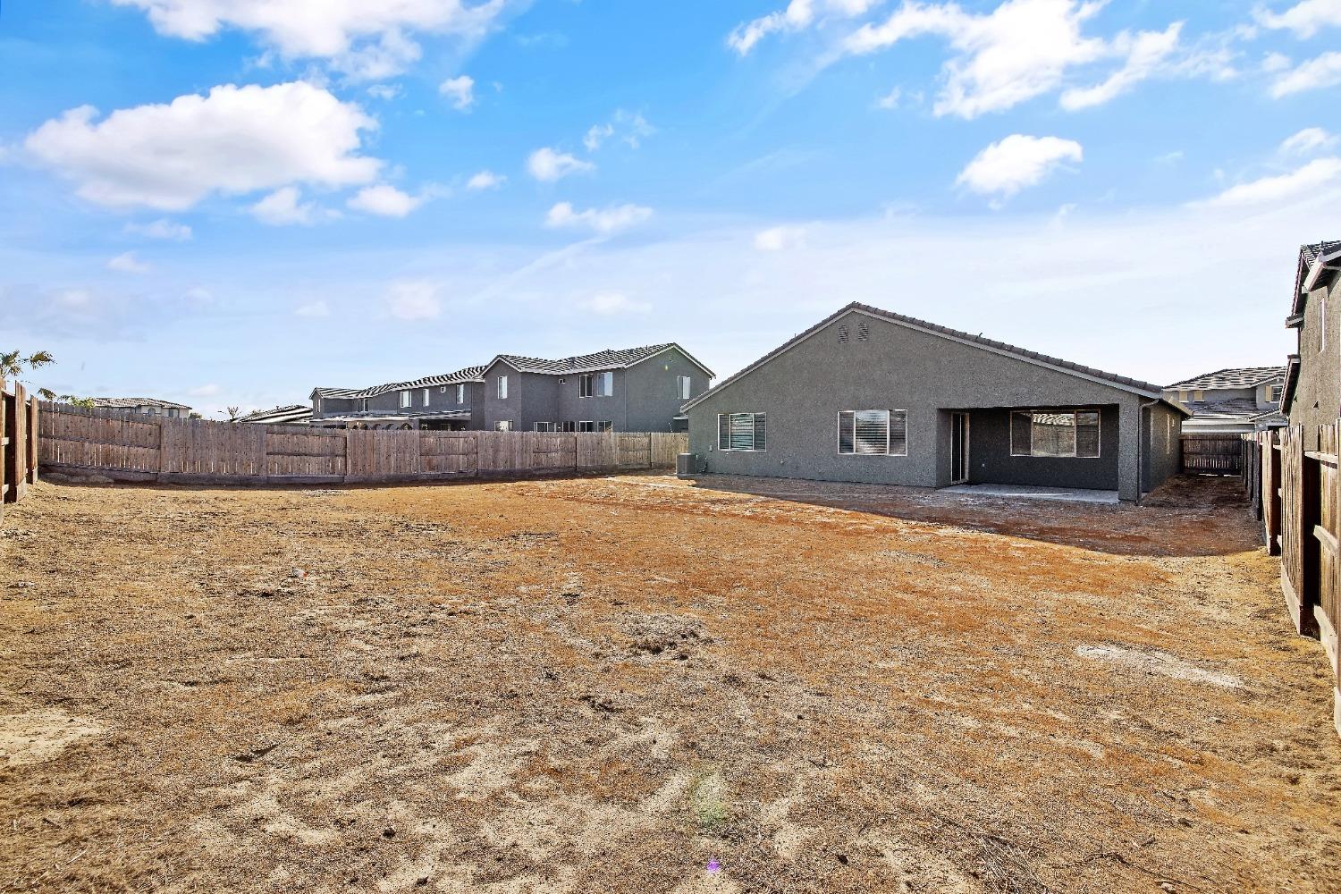 1210 Ridge Creek Estates Way Dinuba, CA 93618 - Photo 46 of 50 a view of a house with a yard