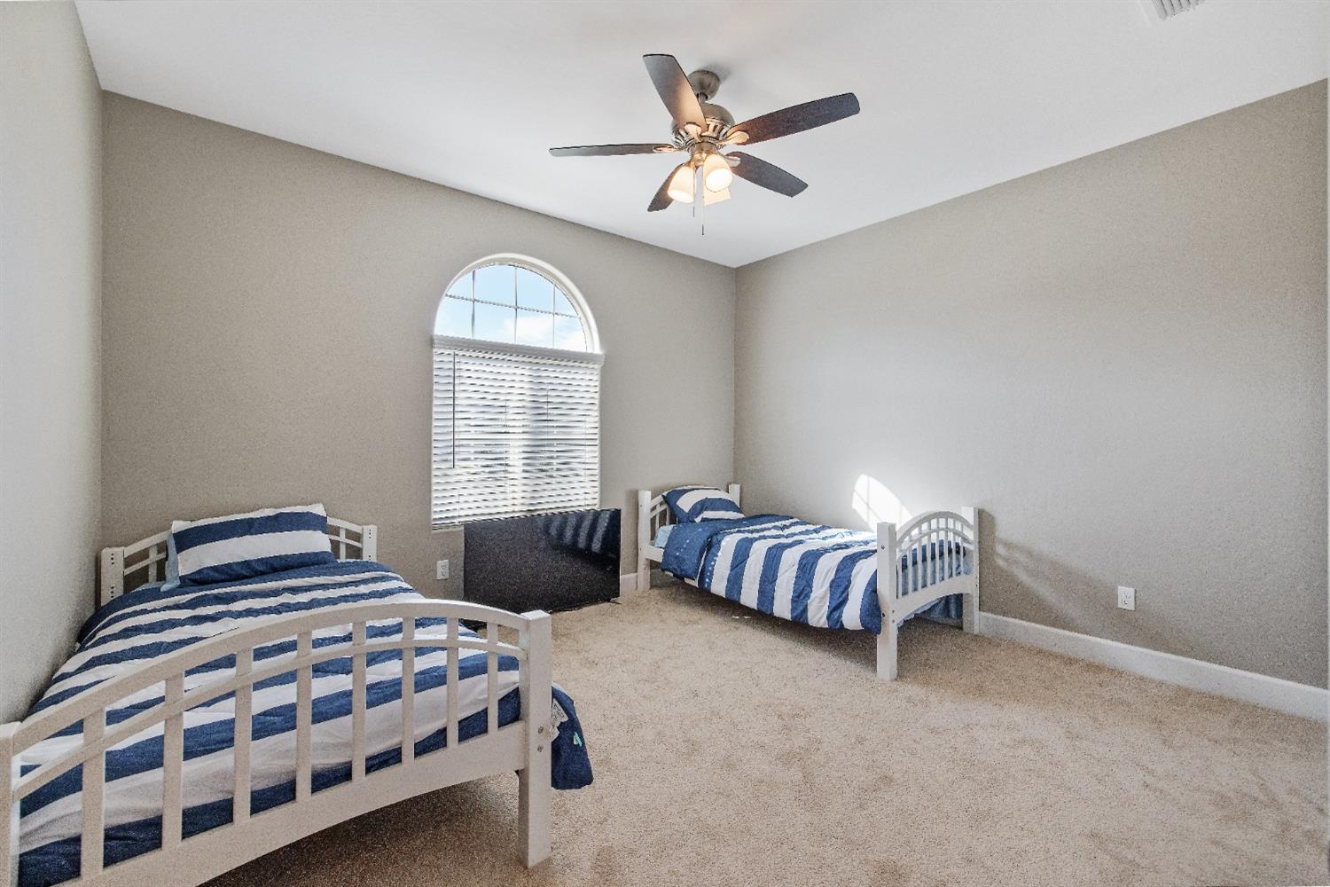 1210 Ridge Creek Estates Way Dinuba, CA 93618 - Photo 8 of 50 a bedroom with a bed and a window