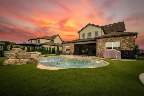 a front view of a house with a garden and patio