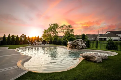 a view of a swimming pool with a yard