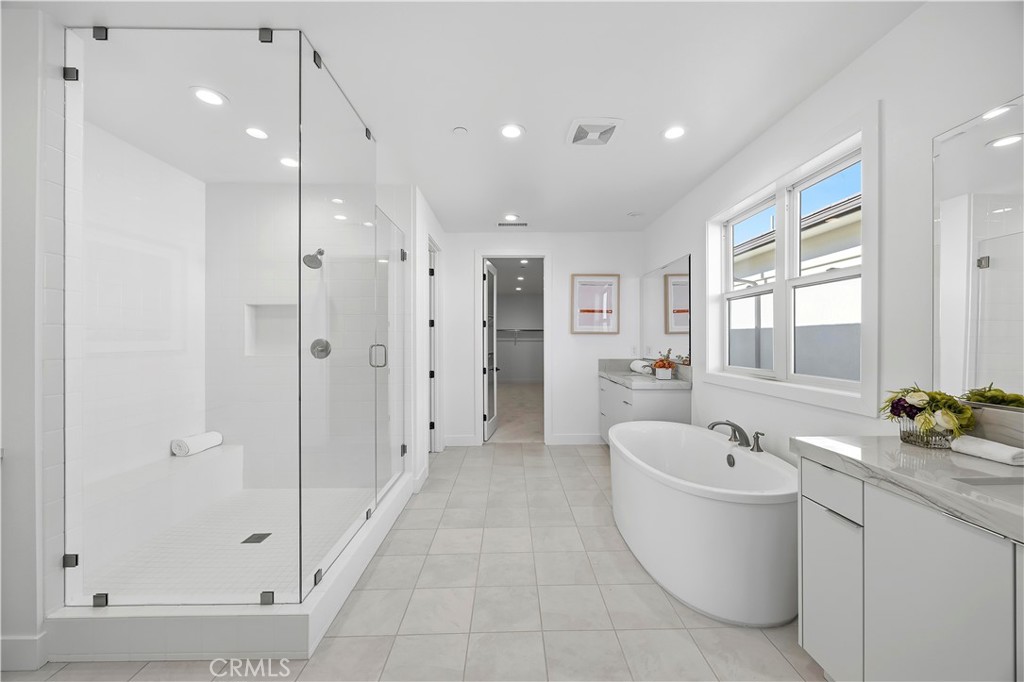 20138 Marlow Lane Porter Ranch, CA 91326 - Photo 23 of 39 a bathroom with a bathtub a shower a sink and mirror