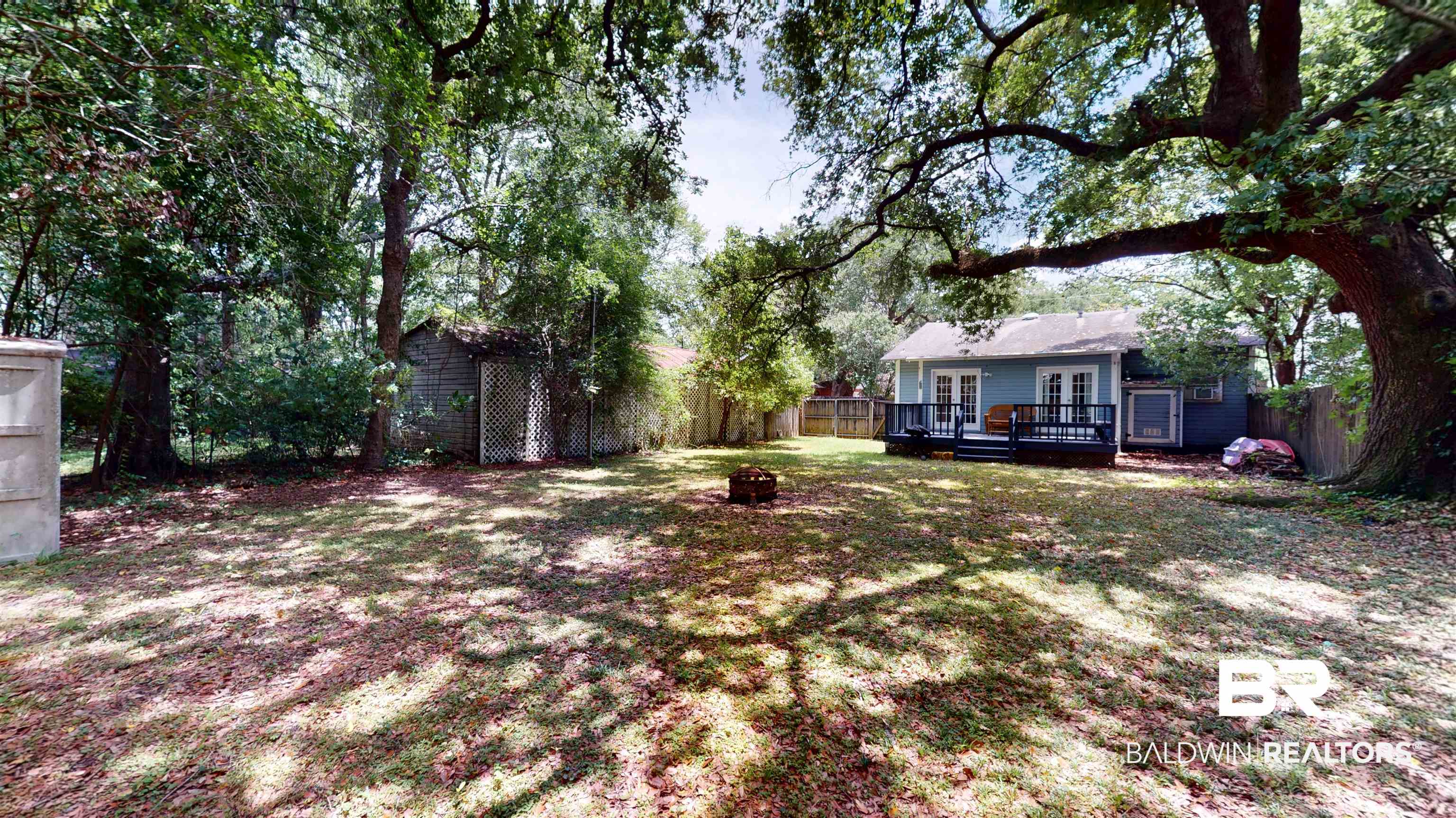 266 Westwood Street Mobile, AL 36606 - Photo 6 of 34 View of yard with french doors, a wooden deck, and a fire pit