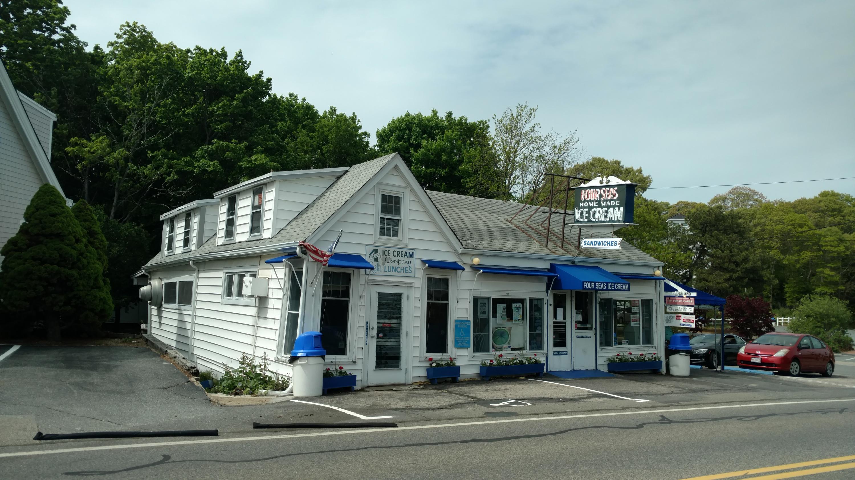 33 Goff Terrace Centerville, MA 02632 - Photo 20 of 22 a view of a white house with large windows and a table and chairs