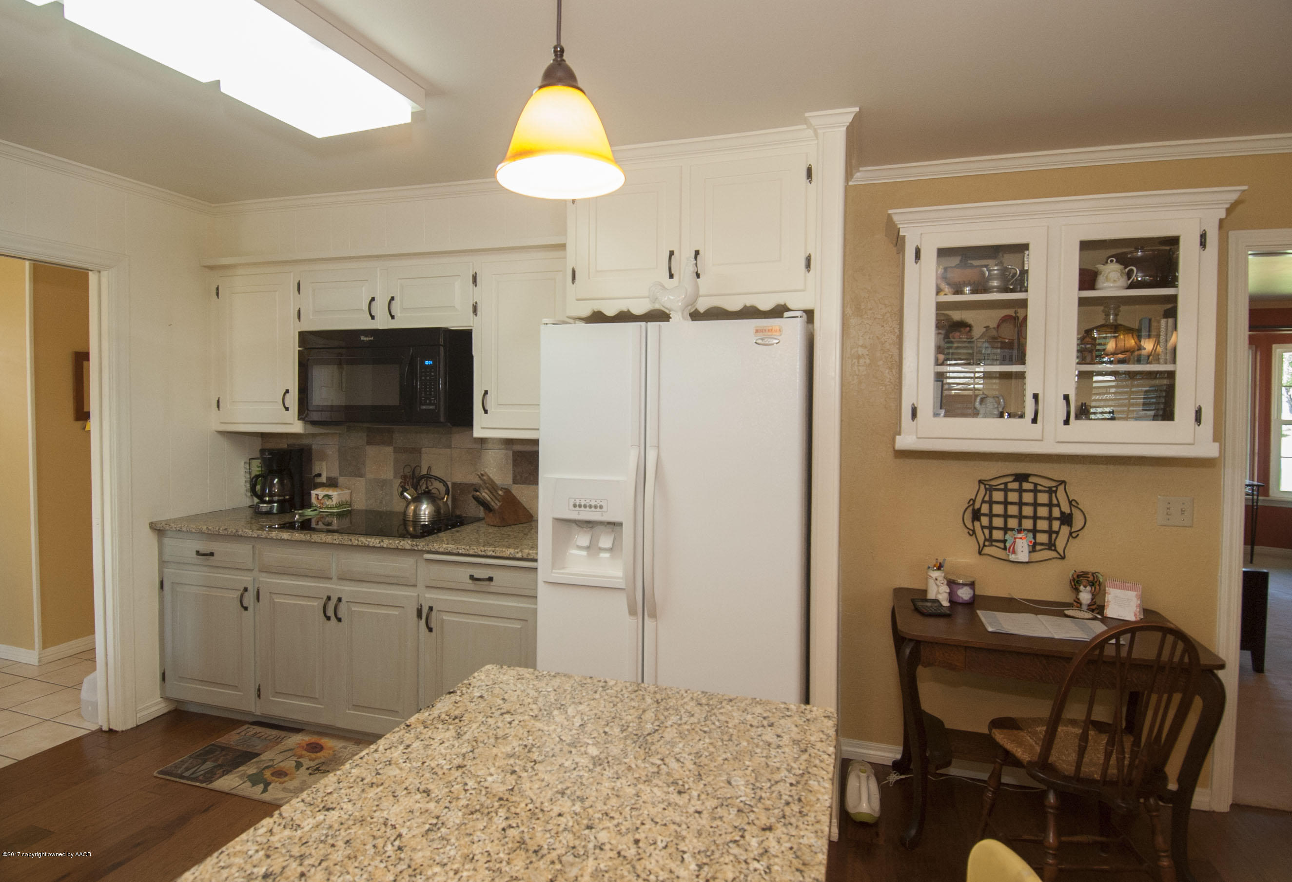 7108 Jameson Road Amarillo, TX 79106 - Photo 8 of 38 a kitchen with a refrigerator cabinets and a table