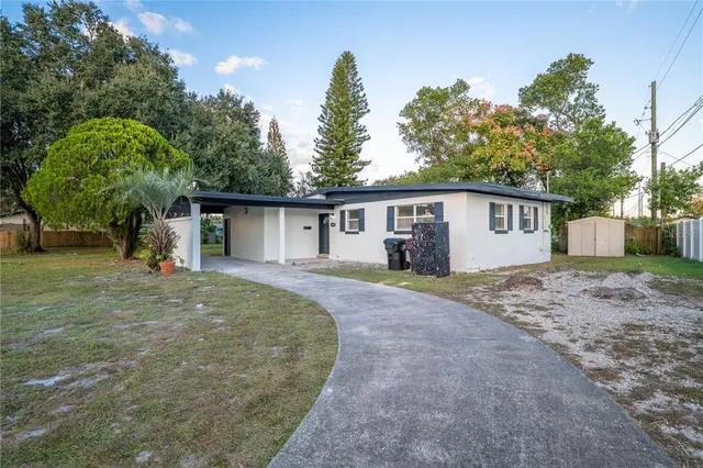 a front view of a house with a yard and trees