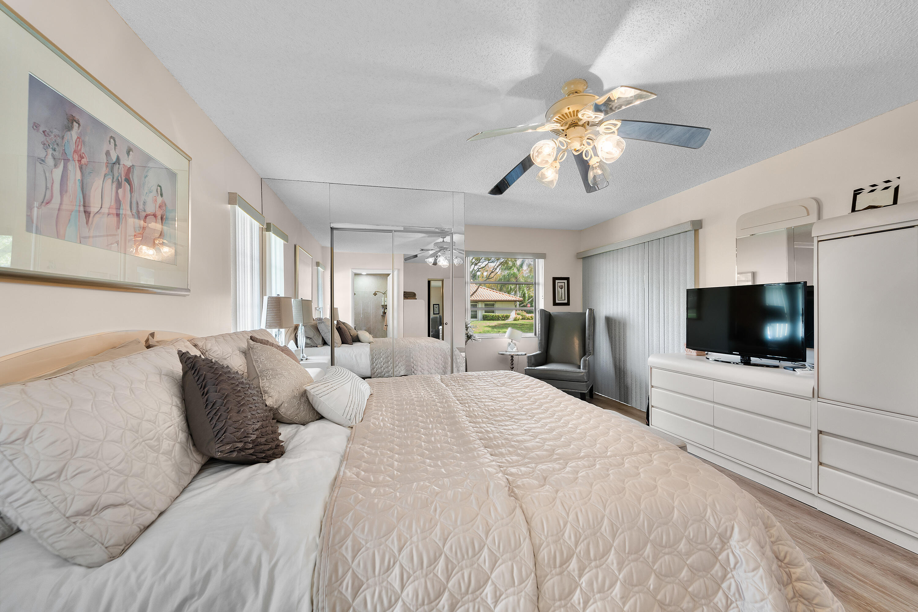 6339 Mill Pointe Circle Delray Beach, FL 33484 - Photo 27 of 61 a bedroom with a bed and a flat screen tv