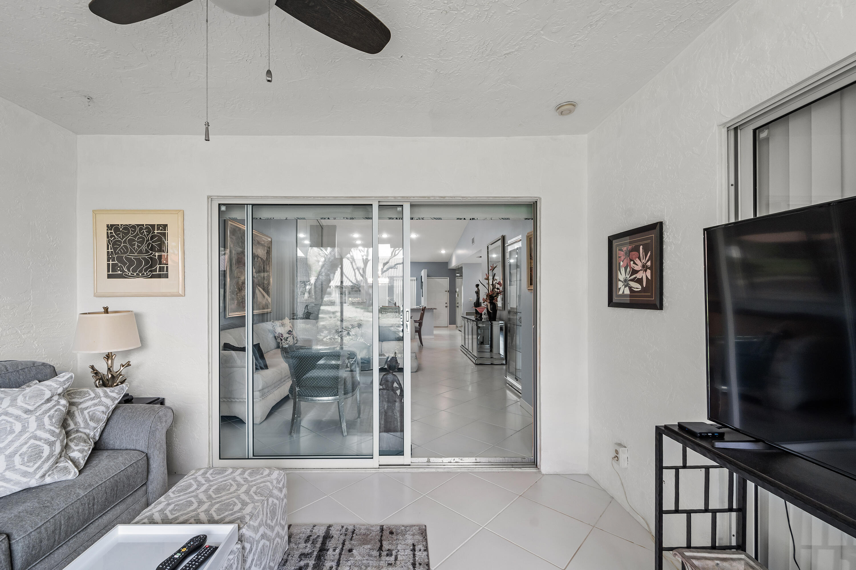 6339 Mill Pointe Circle Delray Beach, FL 33484 - Photo 30 of 61 a living room with furniture and a flat screen tv