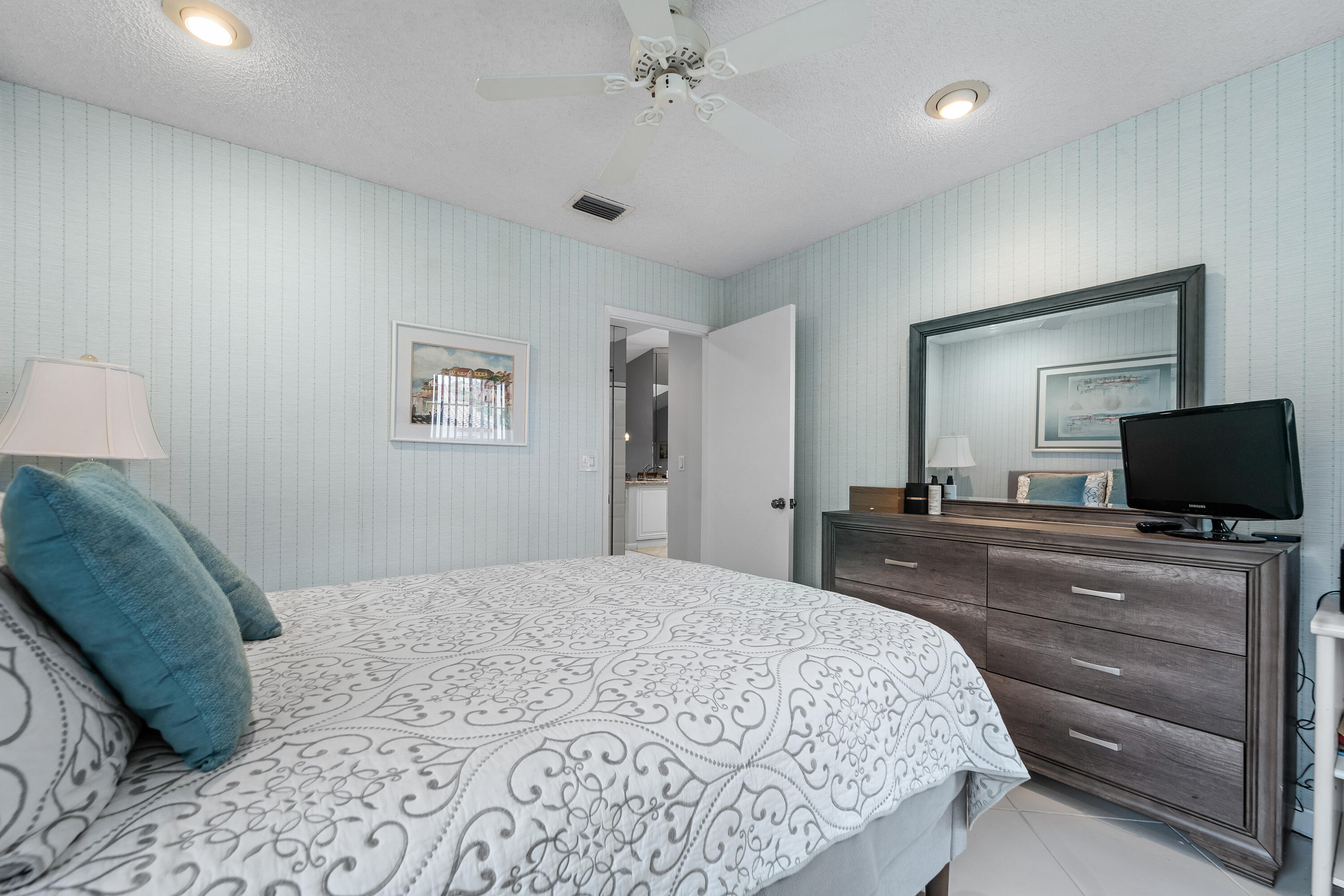 6339 Mill Pointe Circle Delray Beach, FL 33484 - Photo 34 of 61 a bedroom with a bed and a flat screen tv