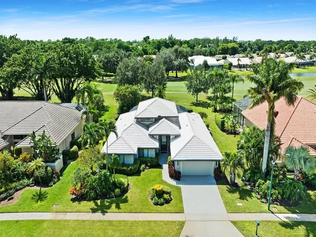 a aerial view of a house with swimming pool garden and outdoor seating