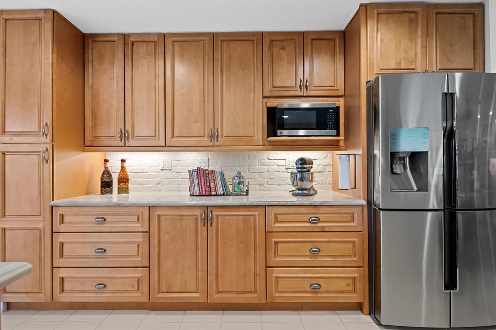 10270 Silver Lake Drive Boca Raton, FL 33428 - Photo 12 of 44 a kitchen with granite countertop a refrigerator and a stove top oven