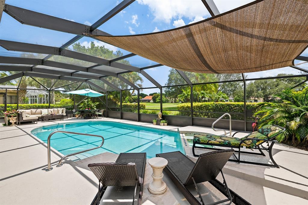 10270 Silver Lake Drive Boca Raton, FL 33428 - Photo 25 of 44 a view of a backyard with table and chairs under an umbrella