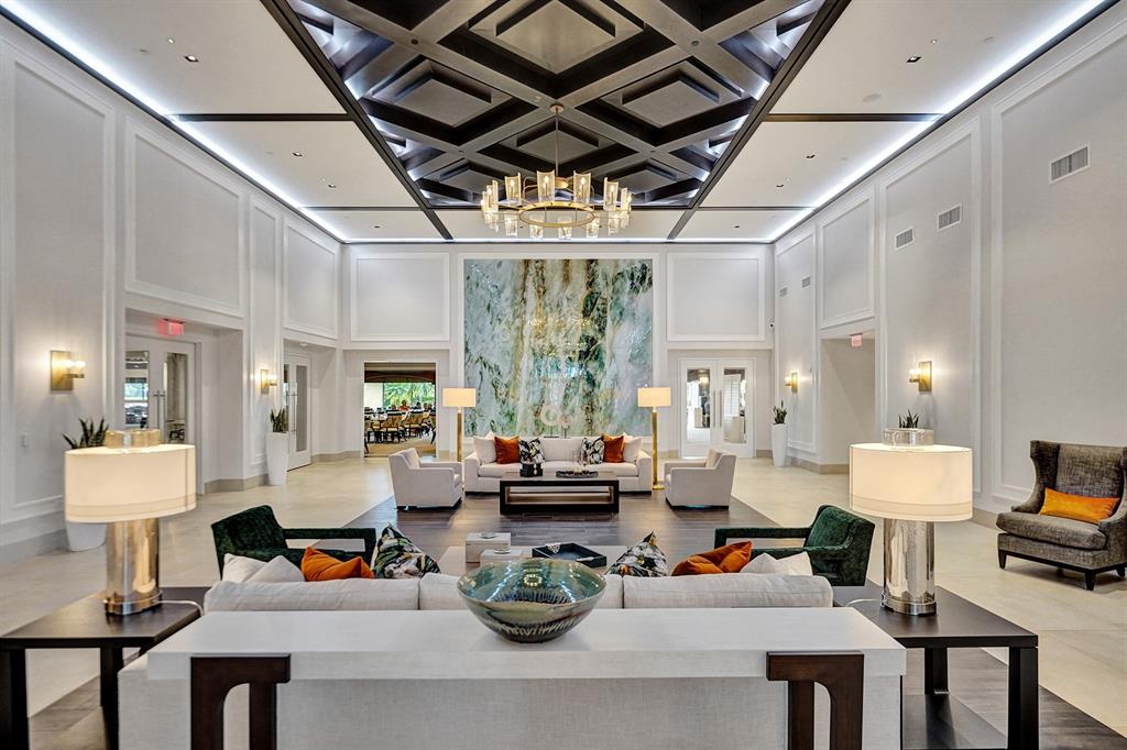 10270 Silver Lake Drive Boca Raton, FL 33428 - Photo 32 of 44 a living room with furniture a fireplace and a chandelier