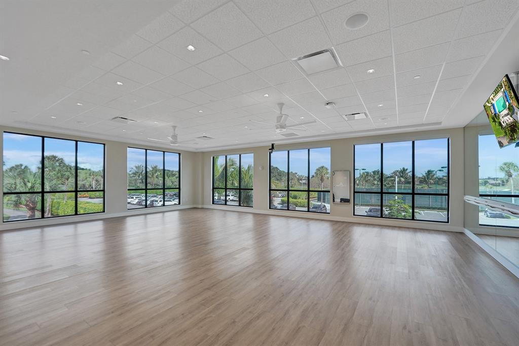 10270 Silver Lake Drive Boca Raton, FL 33428 - Photo 39 of 44 a view of an empty room with wooden floor and a floor to ceiling window