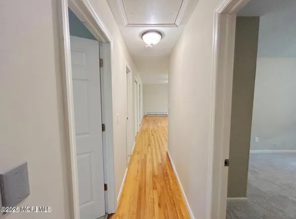 a view of a hallway with wooden floor