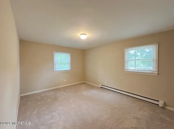 an empty room with a empty space and windows