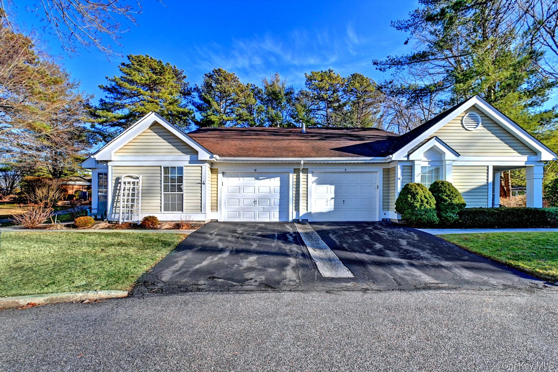 10 Oakdale Court Ridge, NY 11961 - Photo 1 of 41 a front view of a house with a garden