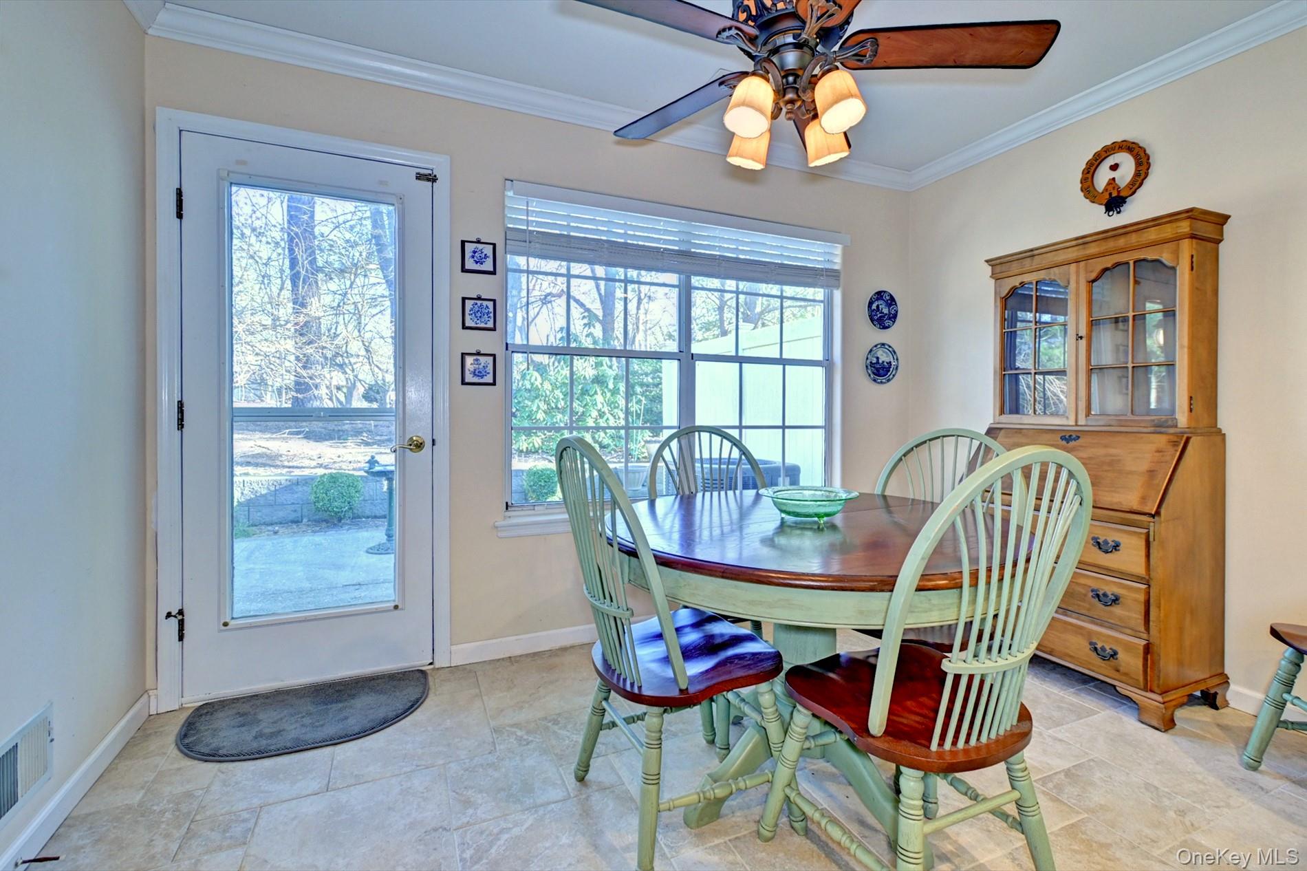 10 Oakdale Court Ridge, NY 11961 - Photo 13 of 41 a dining room with furniture a chandelier and wooden floor