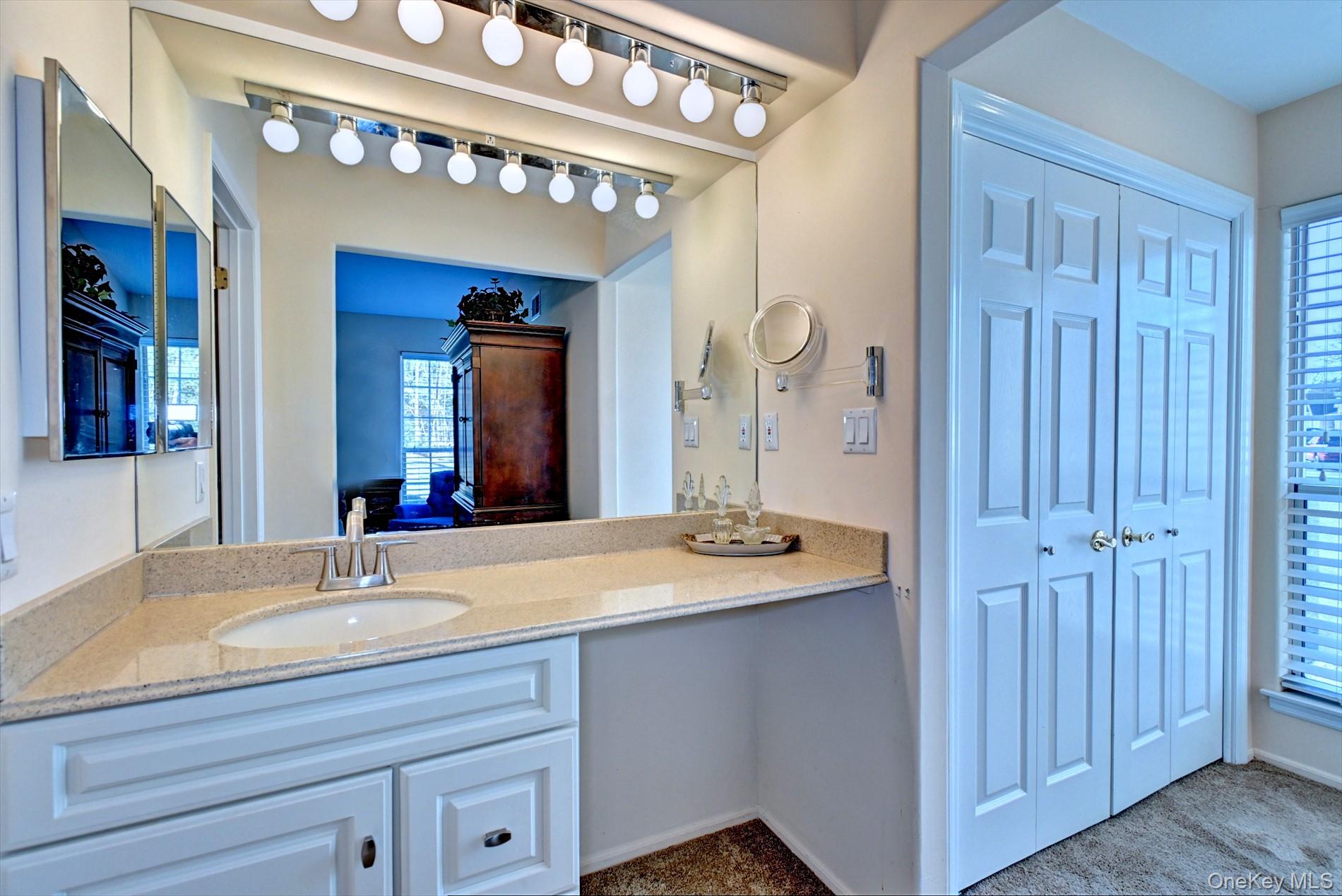 10 Oakdale Court Ridge, NY 11961 - Photo 17 of 41 a bathroom with a sink double vanity and a mirror