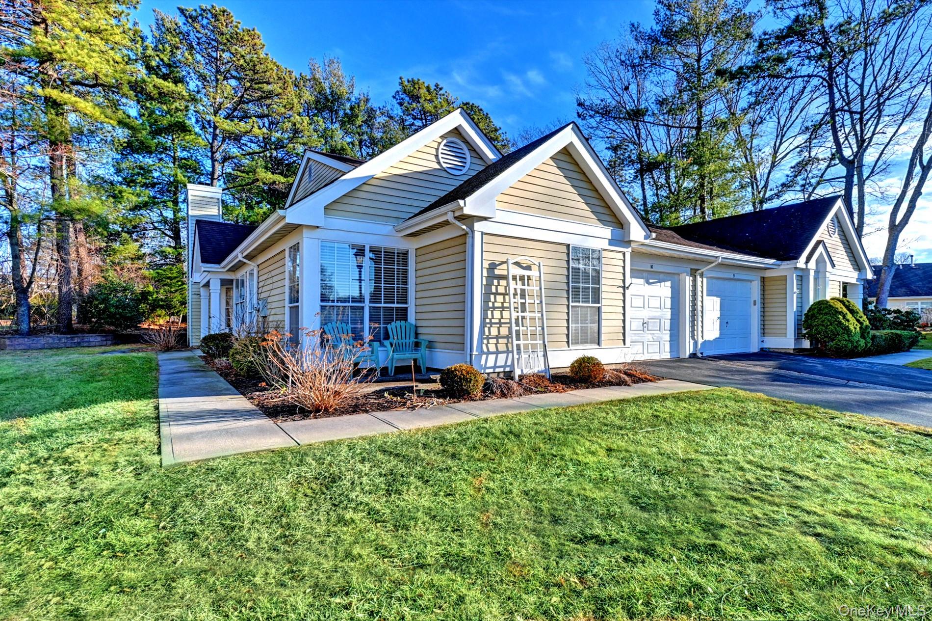 10 Oakdale Court Ridge, NY 11961 - Photo 2 of 41 a view of house with backyard and outdoor seating